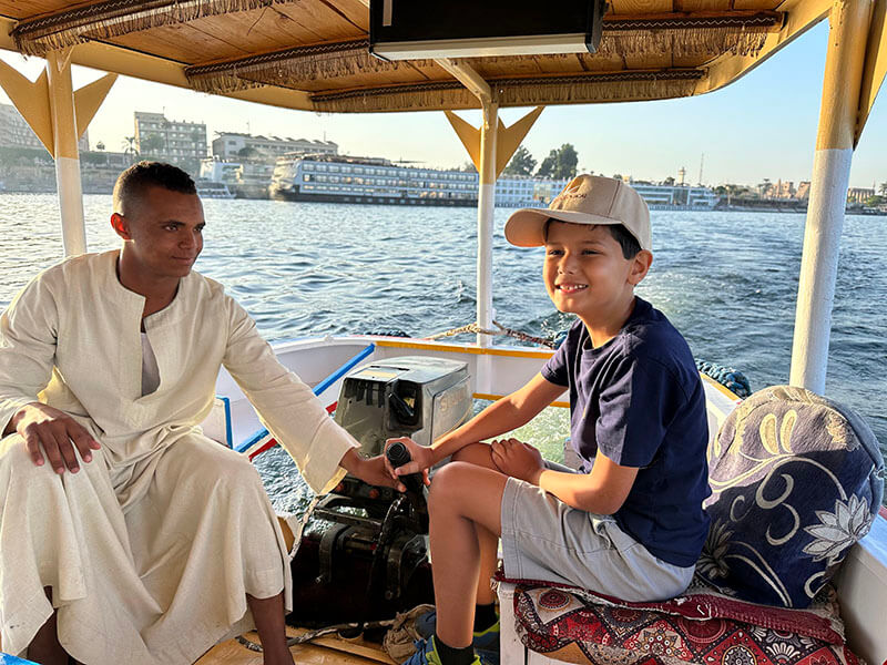 Solomon driving our transfer boat across the Nile River