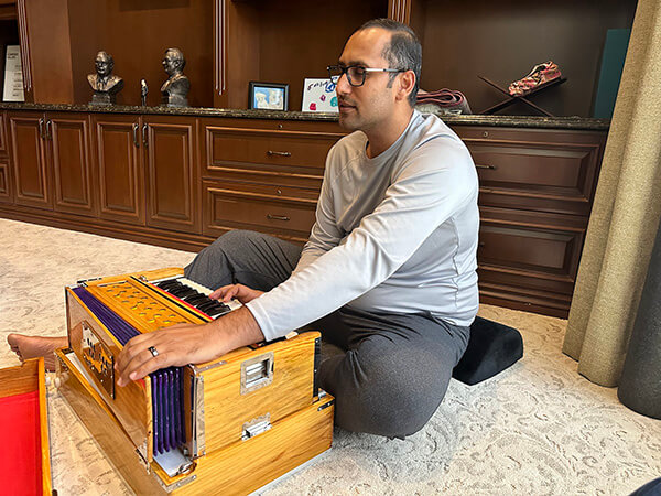 Syed trying to play harmonium