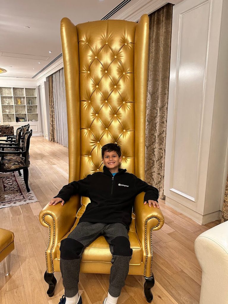 Solomon in a massive chair in our hotel room
